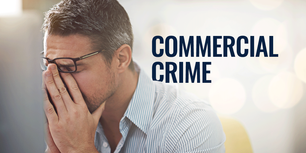 man sat at his computer with his face in his hands looking worried