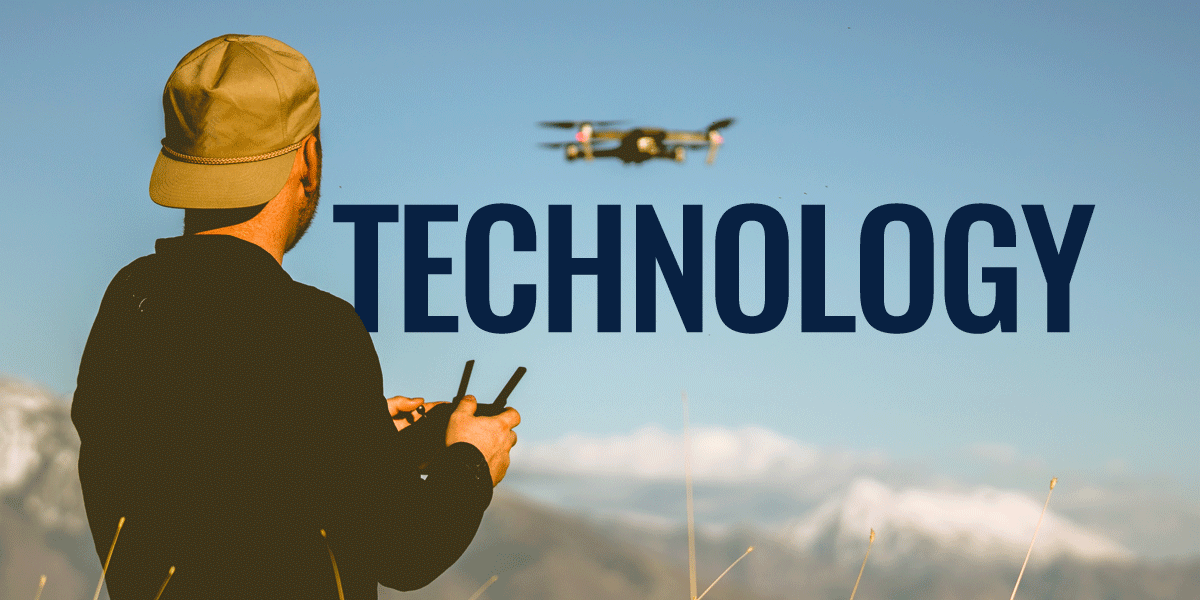 man flying a drone with mountains in the background