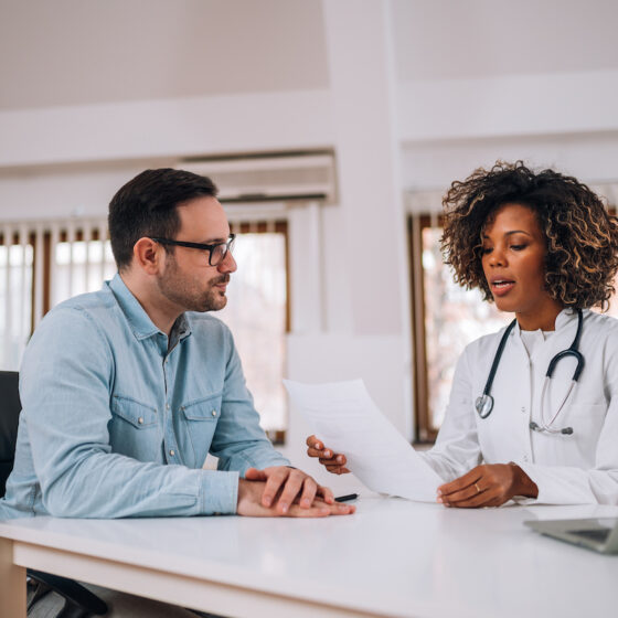 an insurance agent discussing medical malpractice insurance with a doctor