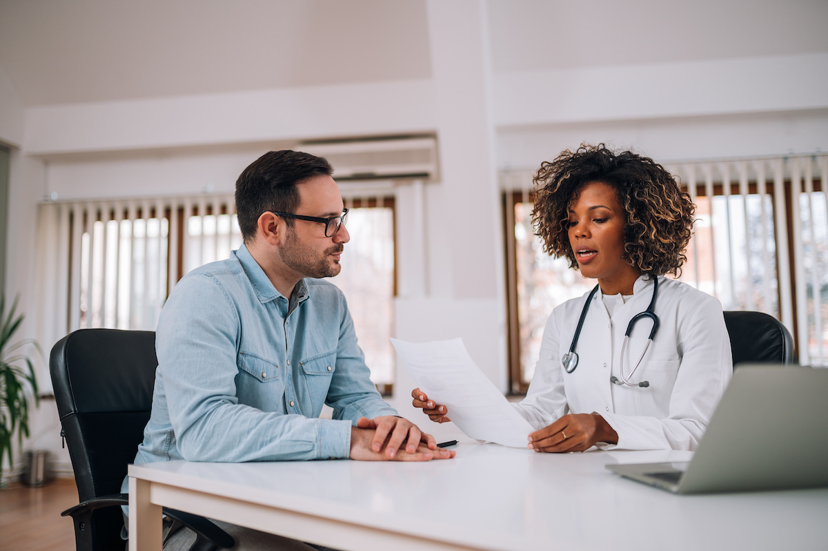 an insurance agent discussing medical malpractice insurance with a doctor