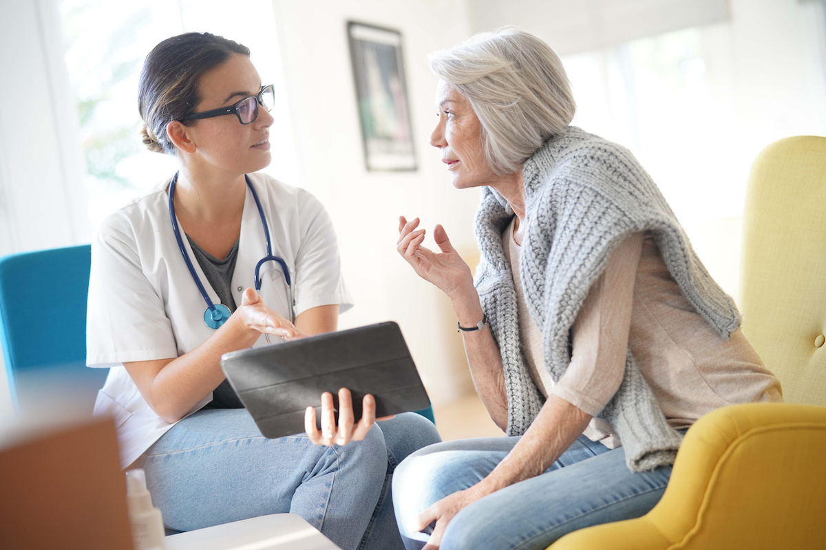 a doctor reviewing the importance of having insurance for her senior living facility