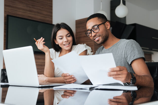 two people reviewing a list of personal insurance policies that they didn't know they needed.