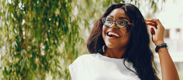 a woman wearing glasses outside